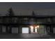 Exterior nighttime view of townhome with garage, welcoming front porch, and well-maintained landscaping at 5077 Camel Heights Rd # C, Evergreen, CO 80433