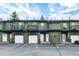 Townhome exterior with garage, balcony, and dark trim at 5077 Camel Heights Rd # C, Evergreen, CO 80433