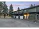 Charming townhome exterior with individual garages surrounded by mature trees and lush landscaping at 5077 Camel Heights Rd # C, Evergreen, CO 80433