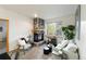 Inviting living room with cozy stone fireplace and bright window view at 5077 Camel Heights Rd # C, Evergreen, CO 80433