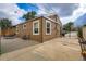 Cozy home featuring backyard patio, concrete pad, side access, and an updated exterior at 6736 Grove St, Denver, CO 80221