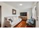 Bright living room showcasing comfortable seating and warm hardwood floors at 6736 Grove St, Denver, CO 80221