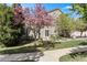 Well-manicured lawn and mature trees surrounding the home's outdoor patio at 9521 Silver Spur Ln, Highlands Ranch, CO 80130