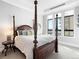 Bright bedroom featuring a four-poster bed and city views at 7600 Landmark Way # 914, Englewood, CO 80111