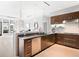 Modern kitchen with sleek cabinetry, stainless steel appliances, and an open layout to the living area at 7600 Landmark Way # 914, Englewood, CO 80111