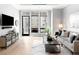 Bright living room with large windows, modern furniture, and a view to the outside balcony at 7600 Landmark Way # 914, Englewood, CO 80111