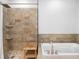 Elegant bathroom features a walk-in shower, soaking tub, and a large vanity at 7600 Landmark Way # 914, Englewood, CO 80111
