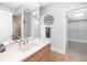 Modern bathroom with a walk-in shower and large vanity at 7600 Landmark Way # 914, Englewood, CO 80111