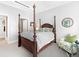Spacious bedroom with a large four-poster bed and sitting area at 7600 Landmark Way # 914, Englewood, CO 80111