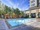 Resort-style pool with lounge chairs and umbrellas at 7600 Landmark Way # 914, Englewood, CO 80111