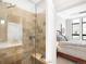 Walk-in shower with tile surround and built-in bench at 7600 Landmark Way # 914, Englewood, CO 80111