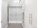 Spacious walk-in closet with custom built-in shelving and hanging rods at 7600 Landmark Way # 914, Englewood, CO 80111