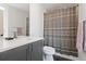 Bathroom with stylish vanity, modern faucet, toilet, and a shower with a patterned curtain at 2851 W 23Rd Ave # 1, Denver, CO 80211