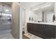 Modern bathroom featuring a glass-enclosed shower, double vanity, and stylish gray cabinetry at 2851 W 23Rd Ave # 1, Denver, CO 80211