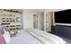 Comfortable bedroom with organized shelving for shoes and modern furnishings, creating a cozy and stylish atmosphere at 2851 W 23Rd Ave # 1, Denver, CO 80211