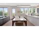 Bright dining area featuring a marble-top table, modern chairs, and a view of lush greenery at 2851 W 23Rd Ave # 1, Denver, CO 80211