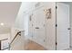 Hallway with white doors and trim, complemented by light hardwood floors and modern wall art at 2851 W 23Rd Ave # 1, Denver, CO 80211