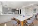 Open concept kitchen with stainless steel appliances, gray cabinetry, and stylish marble dining table at 2851 W 23Rd Ave # 1, Denver, CO 80211
