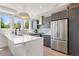 Modern kitchen featuring gray cabinets, stainless steel appliances, and a large white countertop island at 2851 W 23Rd Ave # 1, Denver, CO 80211