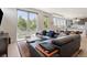 Bright living room featuring large windows, a leather sofa, and an open layout at 2851 W 23Rd Ave # 1, Denver, CO 80211