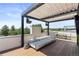 Inviting outdoor living area with covered seating, dining set, and stunning panoramic views at 2851 W 23Rd Ave # 1, Denver, CO 80211