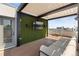 Stylish outdoor living space with a TV, artificial grass wall, and comfortable seating area at 2851 W 23Rd Ave # 1, Denver, CO 80211