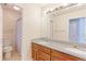 A bathroom with a dual-sink vanity and a shower with a patterned curtain at 2901 Madison Ln, Broomfield, CO 80023