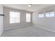 Bright bedroom features neutral walls, plush carpet, and double hung windows with window coverings at 2901 Madison Ln, Broomfield, CO 80023