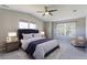 Bedroom featuring a large bed with a tufted headboard and two large windows for natural light at 2901 Madison Ln, Broomfield, CO 80023