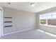 Cozy bedroom boasts soft carpet, ample natural light from a large window, and convenient built-in shelving at 2901 Madison Ln, Broomfield, CO 80023