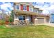 Charming two-story home featuring a cozy front porch, with pristine landscaping, and a well-maintained lawn at 2901 Madison Ln, Broomfield, CO 80023