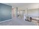Upstairs hallway overlooking the kitchen with staircase featuring metal balusters at 2901 Madison Ln, Broomfield, CO 80023