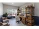 Cozy home office with a wooden desk, shelving, and a comfortable chair in a naturally lit room at 2901 Madison Ln, Broomfield, CO 80023