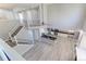 Bright interior view showcasing stairs, kitchen, and high ceilings with a ceiling fan at 2901 Madison Ln, Broomfield, CO 80023