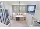 View from the stairs overlooking the living room with a fireplace and a ceiling fan at 2901 Madison Ln, Broomfield, CO 80023
