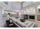 Bright open concept living room featuring a fireplace, high ceilings, and view into the kitchen at 2901 Madison Ln, Broomfield, CO 80023