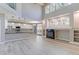 Bright open living space with tall ceilings, fireplace, and kitchen area at 2901 Madison Ln, Broomfield, CO 80023
