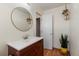 Small bathroom with a vanity, mirror, and potted plants at 1300 Garfield St # 9, Denver, CO 80206
