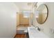 Clean bathroom with a tub shower combo, updated vanity, and a large mirror at 1300 Garfield St # 9, Denver, CO 80206