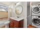 Bathroom with updated vanity, stackable washer/dryer, and a bathtub at 1300 Garfield St # 9, Denver, CO 80206