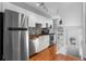 Modern kitchen with stainless steel appliances, butcher block counters, and white cabinetry at 1300 Garfield St # 9, Denver, CO 80206