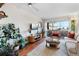 Spacious living room with hardwood floors, sliding glass door to balcony, and plenty of natural light at 1300 Garfield St # 9, Denver, CO 80206