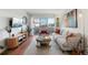 Modern living room with hardwood floors, balcony access, and comfortable seating area at 1300 Garfield St # 9, Denver, CO 80206