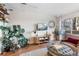 Living room featuring hardwood floors, large plants, and stylish decor at 1300 Garfield St # 9, Denver, CO 80206