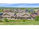 A high aerial captures the neighborhood layout, homes, and common area with clear mountain views on the horizon at 1130 Summit View Dr, Louisville, CO 80027