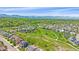 Expansive aerial showcases the neighborhood homes, green spaces, pathways, and majestic mountain views beyond at 1130 Summit View Dr, Louisville, CO 80027