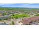 A wide aerial shows the community park, winding sidewalks, well-kept lawns, and distant mountain views at 1130 Summit View Dr, Louisville, CO 80027