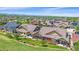 An aerial view showcases the residential neighborhood, mountain views, and well-manicured lawns at 1130 Summit View Dr, Louisville, CO 80027