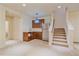 Finished basement includes a kitchenette, carpet, and stairs to main floor at 1130 Summit View Dr, Louisville, CO 80027