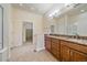 Bathroom featuring double vanity, granite counters, tile floors, and walk-in closet at 1130 Summit View Dr, Louisville, CO 80027